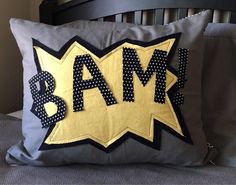 a pillow that has the word bam on it