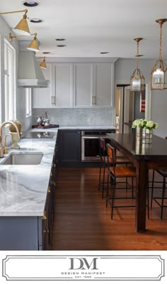 a kitchen with an island, sink and stove top oven next to a dining room table