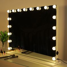 a vanity mirror with lights on top of it