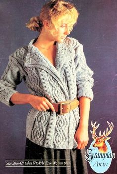 a woman is wearing a sweater and belt