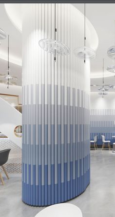 an office lobby with blue and white walls, round tables and chairs in the background