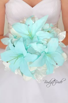 a bride holding a bouquet of blue flowers