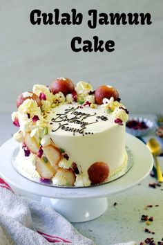 there is a cake with fruit on it and the words gulab jamun cake