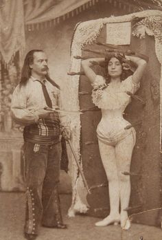 an old photo of a man and woman standing next to each other