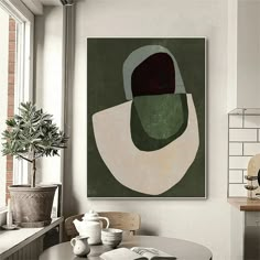 a painting hanging on the wall above a table in a room with a potted plant