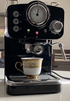 an espresso machine with a coffee cup on it