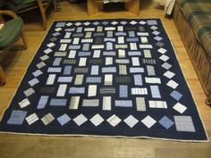 a blue and white quilt on the floor