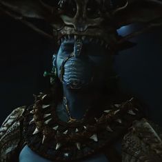 an alien woman with horns and spikes on her head in a dark room, looking at the camera