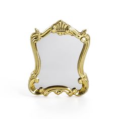 a gold framed mirror on a white background