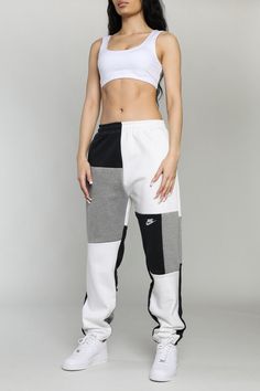 We updated our classic patchwork sweatpants with a straight leg fit for the perfect stack. Upcycled from 3 thrifted sweatshirts. Sourced and reworked in Canada.   DetailsSize: XS, S, MCondition: Good vintage conditionColour: Black, grey, white with embroidered nike logo and swoosh *Model is 5'10, waist 26", hips 38", u Reworked Sweatpants, Reworked Corset, Patchwork Outfit, Patchwork Sweatpants, Reworked Flannel, Reworked Sweatshirts, Reworked Nike, Nike Vest, Patchwork Hoodie