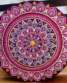 an intricately designed plate with pink and purple colors