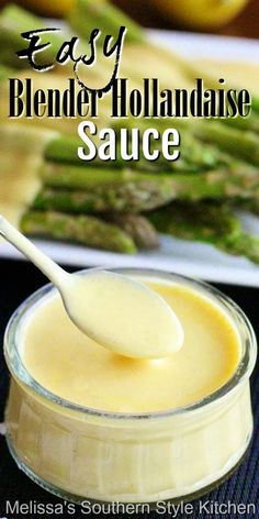 a spoon full of sauce on top of asparagus with the words easy blender hollandaise sauce