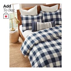 a bed with blue and white checkered comforter set on it's side