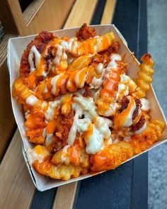 a box filled with lots of food on top of a wooden table