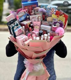 a person is holding a bouquet full of items