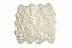 a white sheepskin rug on a white background