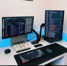 two computer monitors sitting on top of a desk next to a keyboard, mouse and monitor