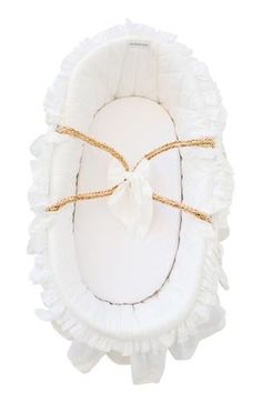 a white baby bassinet with ruffles tied up to it's sides