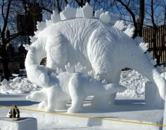 an ice sculpture of two elephants and a cat in front of it with the words reason to love edmonton written below