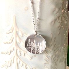 A stunning silver pine tree necklace for the nature lover! This piece is hand stamped with a lovely forest scene of our beautiful surroundings. A perfect gift to give the nature enthusiast! 🌿 Chain is a solid sterling silver satellite chain. You may choose your length at checkout. 🌿 Choose to have stars in your sky, or without. (shown in photos) 🌿 Silver disk is 2cm in diameter and made from alkeme. Please see all photo's for size reference. Alkeme is lead, nickel, and cadmium free and tarnis