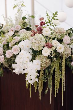 an arrangement of flowers in a wooden box