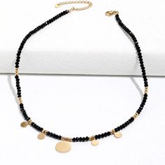 This one-of-a-kind Tori Black Beaded Necklace is sure to catch eyes with its bold mix of edgy black and glitzy gold. A shimmering statement piece for daring fashionistas, it'll add a modern touch to any look! #stylegameonpoint Size: 16 inches with 2 inch extender Materials: Stainless Steel 18K Gold Plated Gold Beaded Metal Necklaces, Party Necklace With Gold Beads, Black Necklaces With Round Gold Beads, Trendy Metal Beaded Choker Necklace, Party Beaded Necklaces With Metal Beads, Party Beaded Metal Necklaces, Party Metal Beaded Necklaces, Trendy Black Beaded Jewelry, Trendy Black Beaded Necklaces With Round Beads