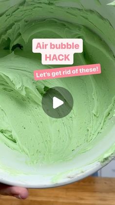 someone is holding up a green cake that looks like an air bubble hackr and it says, let's get rid of these