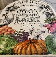 an oven cover with vegetables and fruits painted on the front, along with words about fresh local honey