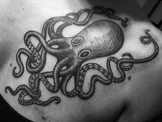 an octopus tattoo on the back of a woman's shoulder