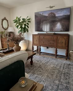 a living room filled with furniture and a large flat screen tv mounted to the wall