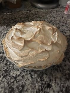 a pie sitting on top of a counter covered in frosting