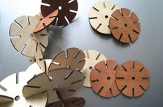 several wooden discs are arranged on a table top with holes in the middle to make them look like they have been cut from wood