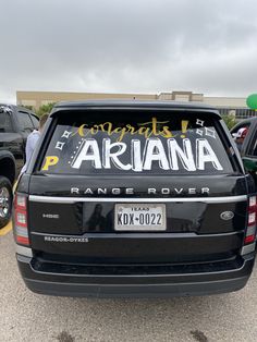 the back end of a black truck with an ariana sticker on it's tailgate