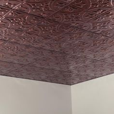 the ceiling is covered in intricately designed tint and has been painted with metallic paint