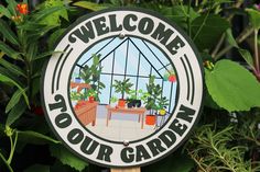 a welcome sign in front of some plants