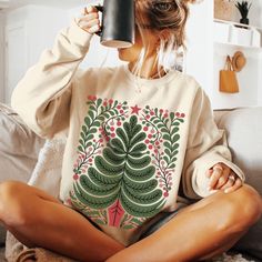 This Nordic style Christmas design is printed directly on a classic Gildan unisex sweatshirt with drop sleeves. When you think of a sweatshirt, this is one that should come to mind. If you prefer an oversized look, go up 1-2 sizes.  As all of our shirts are made to order, there are no refunds - make sure you are ordering the correct size. If there is any problem whatsoever with the printing or the garment itself, please contact me for assistance.  * 50% cotton, 50% polyester * Pre-shrunk * Class Nordic Style Christmas, Nordic Folk Art, Art Sweater, Scandinavian Christmas, Graphic Shirt, Nordic Style, Christmas Design, Christmas Sweatshirts, Graphic Shirts