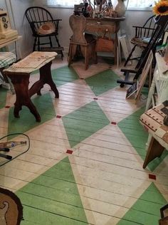 a room with green and white checkered flooring next to two chairs in front of a window