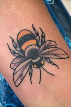 a tattoo with a bee on it