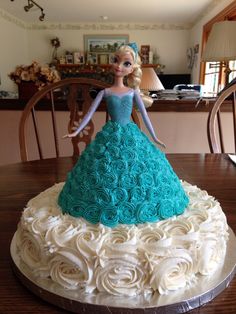 there is a cake that has been made to look like a princess on the table