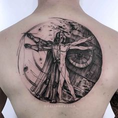 a man with a tattoo on his back that has a drawing of the crucifix