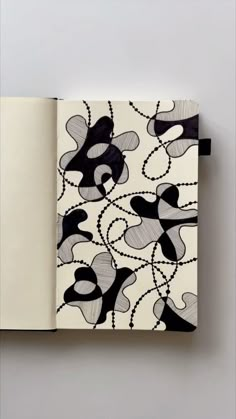 an open notebook with black and white designs on it