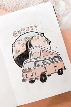 a notebook with an illustration of a van driving down a road and the words august above it