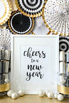 a black and gold new year's eve party with paper fan decorations on the wall