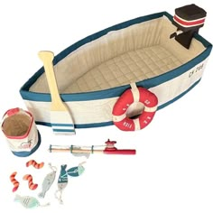 an inflatable toy boat with accessories including a paddle, oars and sand