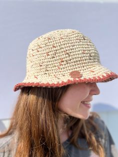 a woman with long hair wearing a white and red hat on top of her head