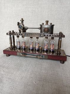 an old fashioned machine with eight tubes on it