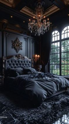 a bedroom with black walls, chandelier and bed in front of large windows