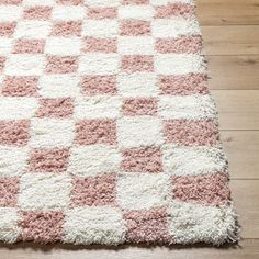 a pink and white rug on the floor