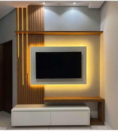 the television is mounted on the wall in the living room, and it's illuminated by leds