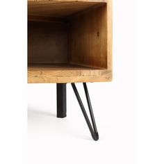 a wooden shelf with two black hair pins sticking out of it's bottom section